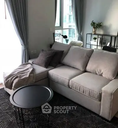 Modern living room with cozy gray sofa and stylish decor