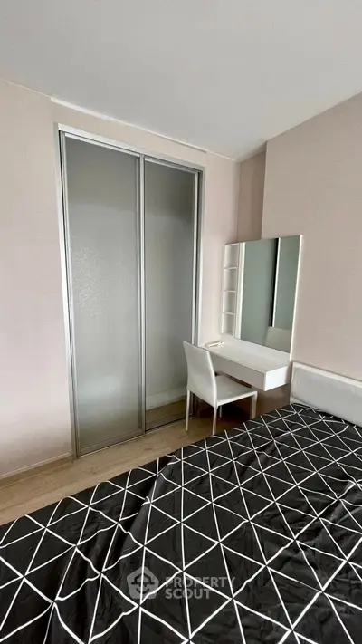 Modern bedroom with sleek sliding closet doors and stylish vanity set