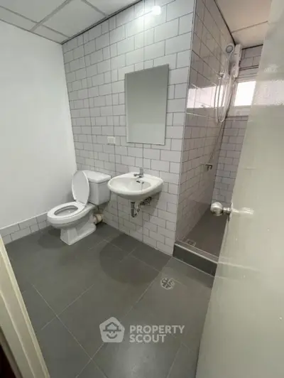 Modern bathroom with sleek tiles and compact design