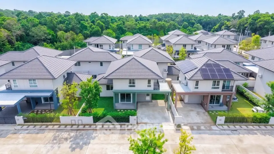 Modern suburban homes with solar panels and lush greenery in a serene neighborhood.