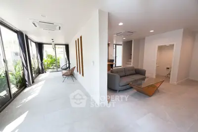 Spacious modern living room with large windows and stylish furniture