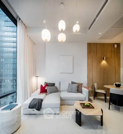 Modern living room with stylish decor and large windows in a high-rise apartment.
