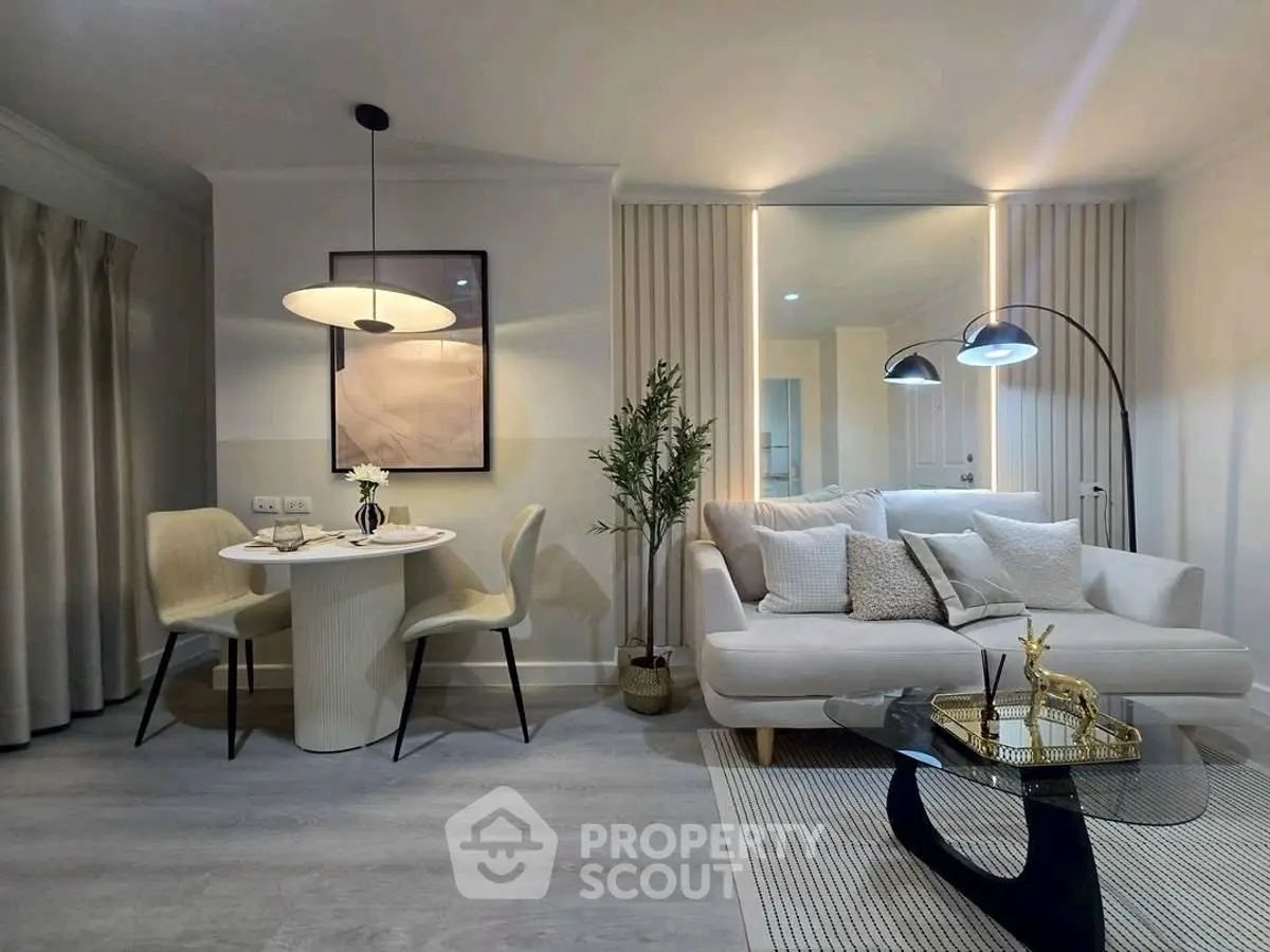 Modern living room with elegant decor and cozy dining area, perfect for stylish urban living.