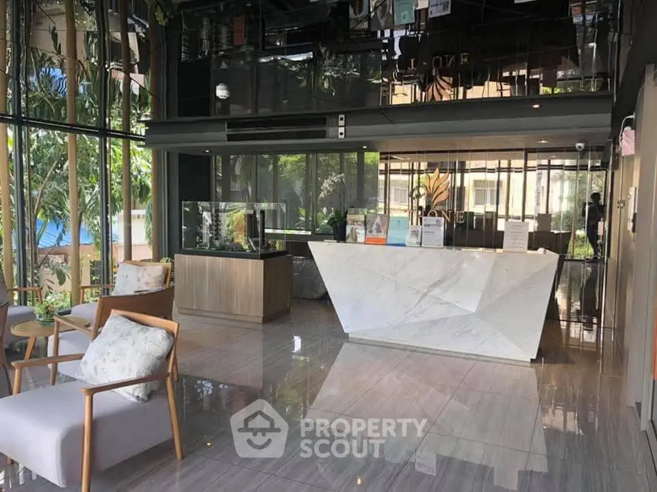 Luxurious modern lobby with sleek marble reception and elegant seating area.
