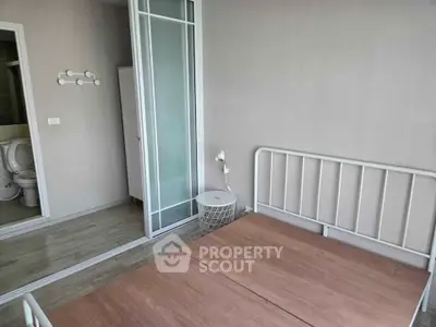 Modern bedroom with minimalist design and sliding door to bathroom