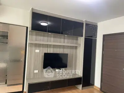 Modern living room with sleek TV unit and storage cabinets