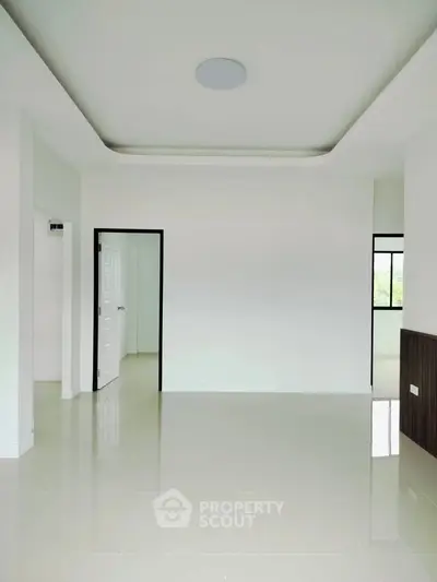 Spacious modern interior with sleek white walls and glossy tiled flooring