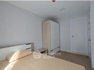 Modern minimalist bedroom with wooden wardrobe and neutral tones.