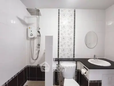 Modern bathroom with sleek design and shower area in a stylish apartment.