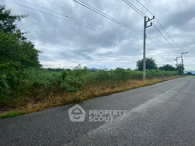 Expansive land plot with lush greenery and clear skies, ideal for development or investment opportunities.