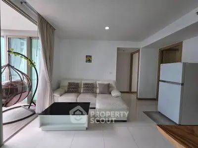 Modern living room with white sectional sofa and balcony view