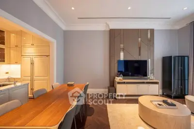 Spacious modern living room with elegant dining area and sleek kitchen design.
