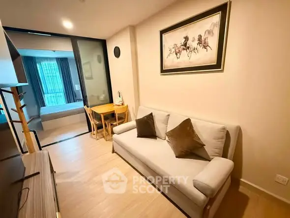 Modern living room with cozy sofa and stylish decor in a contemporary apartment.