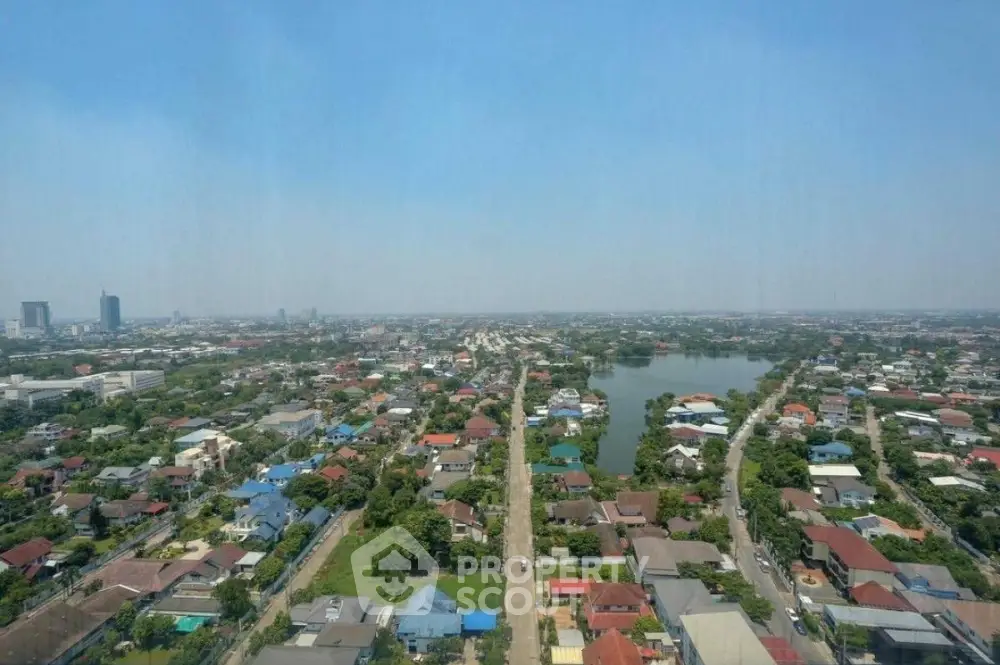 Stunning aerial view of a sprawling residential neighborhood with lush greenery and a serene lake.