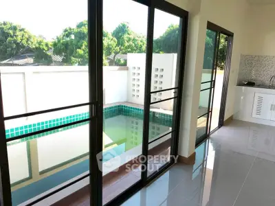 Modern home with private pool and sleek kitchen, perfect for luxury living.