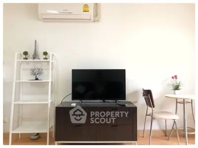 Modern living room with air conditioning, TV, and stylish decor in a cozy apartment.