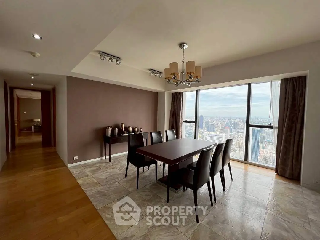 Elegant dining area with stunning city view, featuring modern decor and ample natural light.