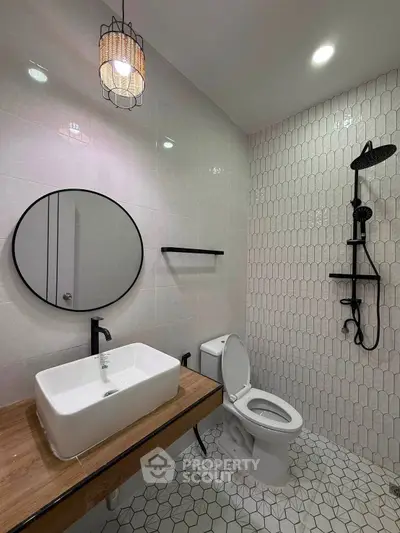Modern bathroom with stylish fixtures and geometric tile design