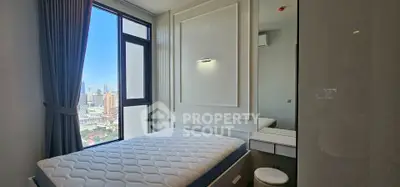 Modern bedroom with city view, featuring a large window and stylish decor.