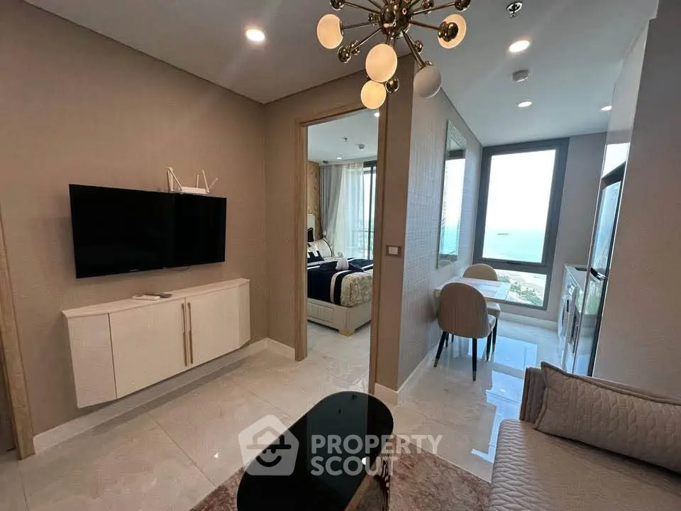 Modern living room with ocean view, stylish decor, and elegant lighting in a luxury apartment.