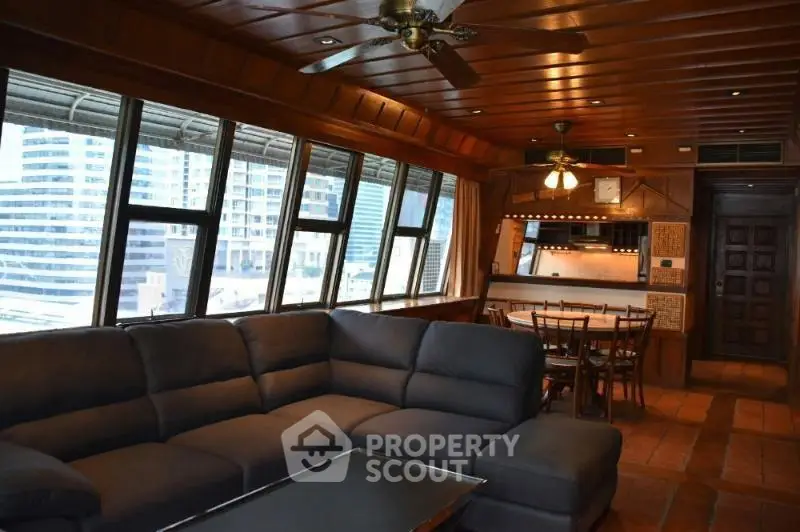 Luxurious living room with panoramic city views and elegant wooden interiors.
