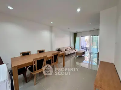 Spacious open-plan living and dining area with modern furnishings and natural light.