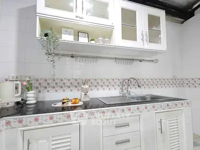 Charming kitchen with floral accents and modern cabinetry