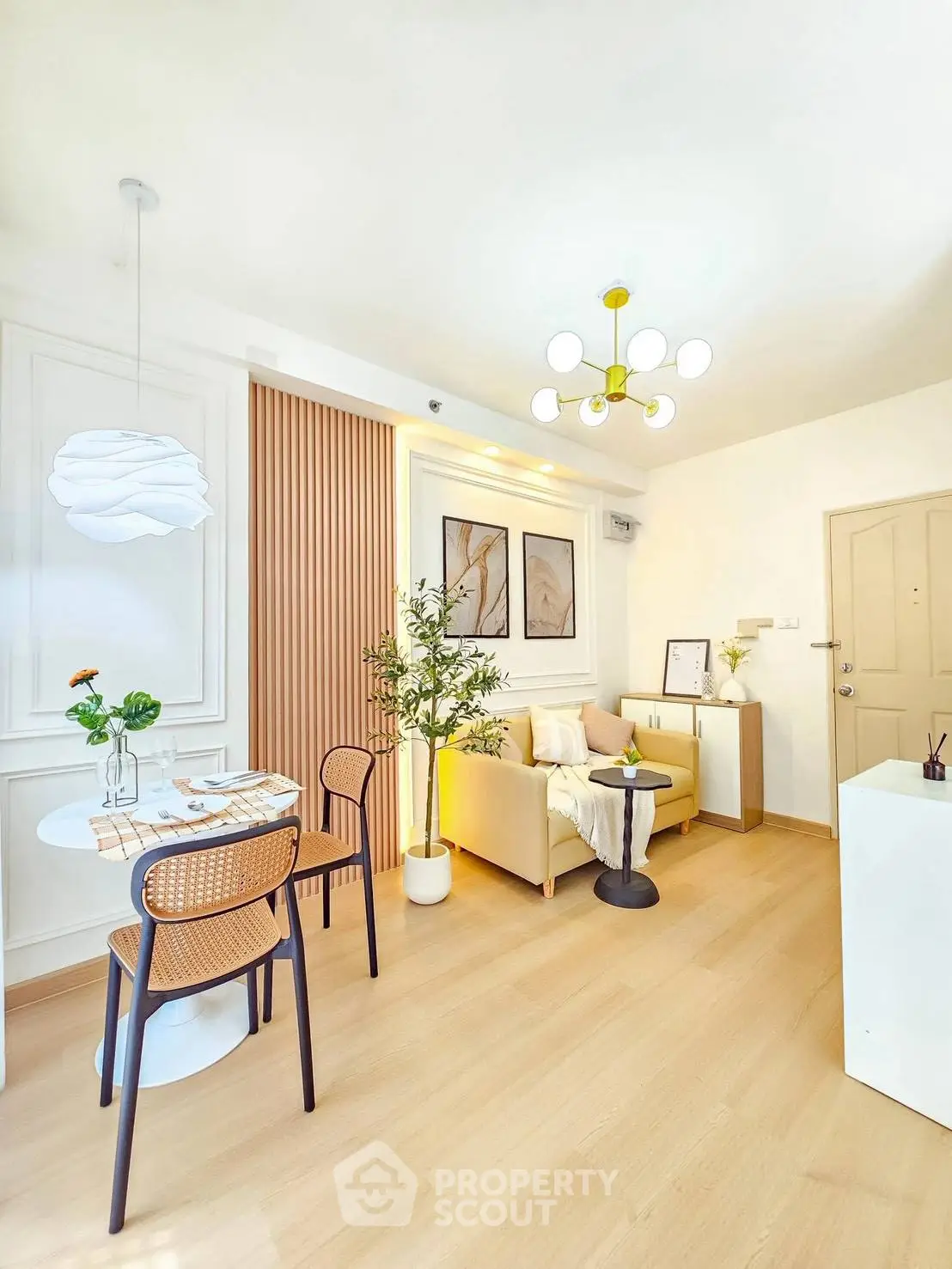 Modern living room with stylish decor and dining area, featuring elegant lighting and contemporary furniture.