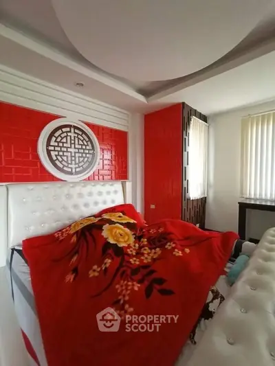 Luxurious bedroom with vibrant red accents and elegant decor