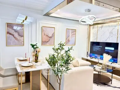 Luxurious living room with elegant decor, marble accents, and modern lighting, perfect for sophisticated living.