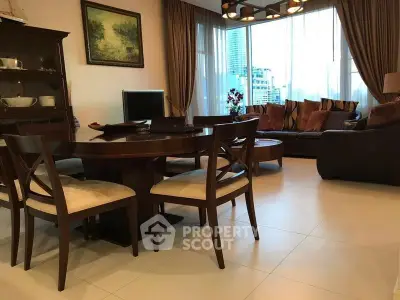 Elegant living room with modern furniture and large windows offering city views.