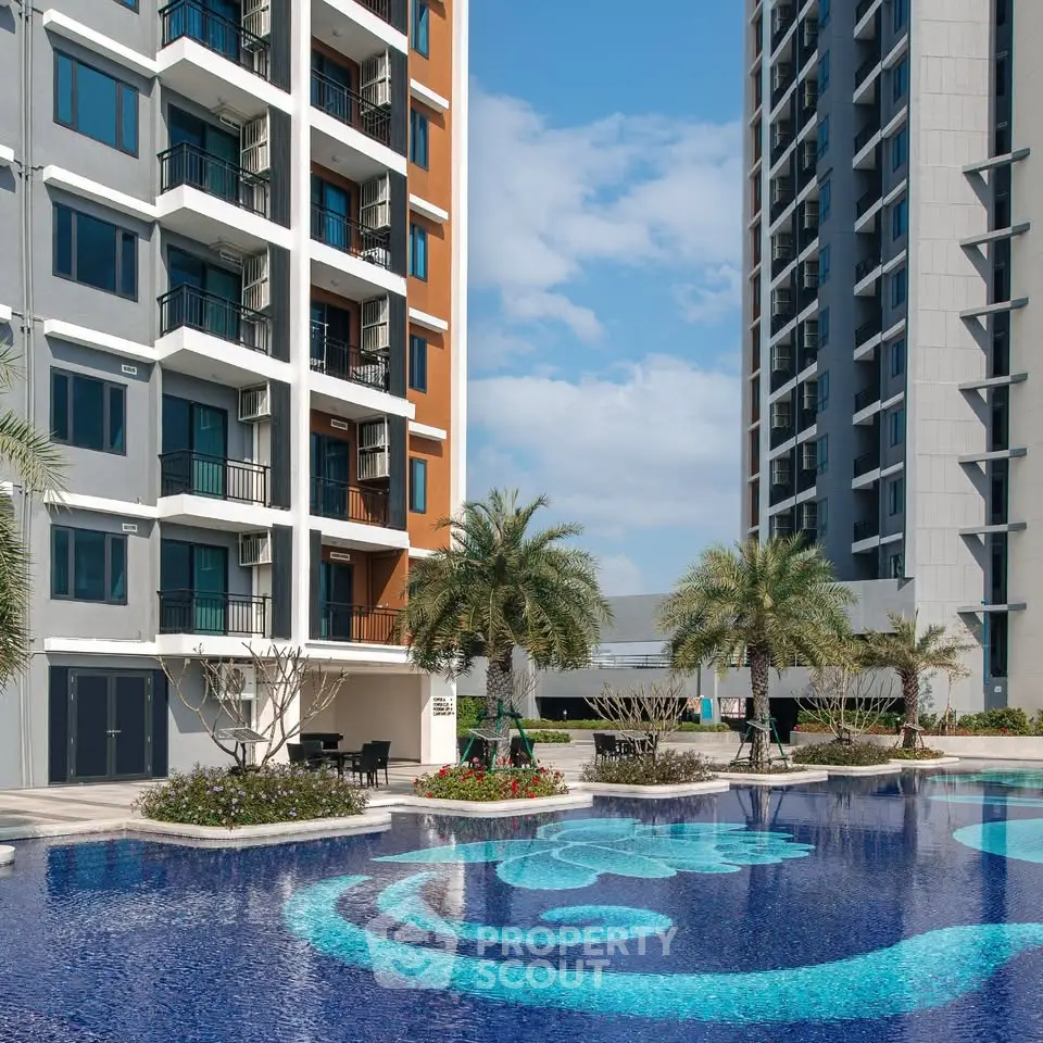 Luxurious apartment complex with stunning pool and modern architecture.