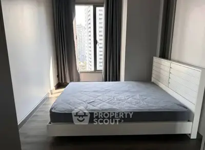 Modern bedroom with large window and minimalist design in urban apartment