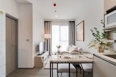 Modern living room with elegant decor and dining area in a cozy apartment