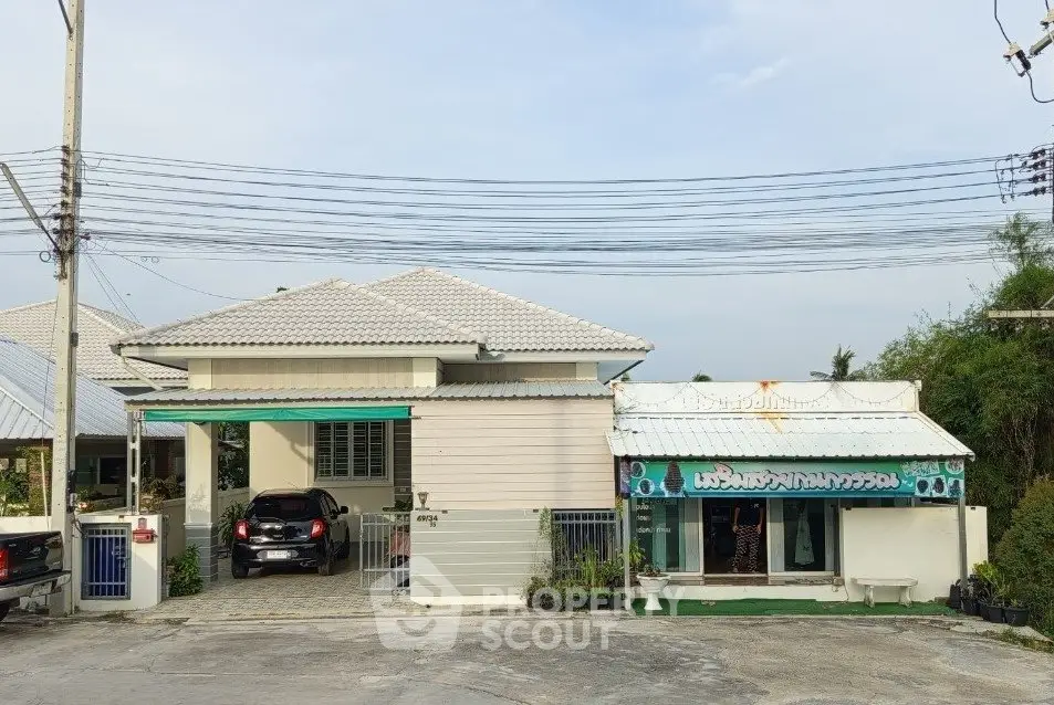 Charming suburban home with attached carport and adjacent small shop, ideal for residential and business use.
