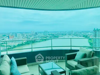 Stunning balcony view overlooking a river and city skyline, perfect for relaxation.