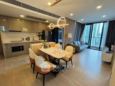 Modern open-plan living room with stylish kitchen and city view balcony.
