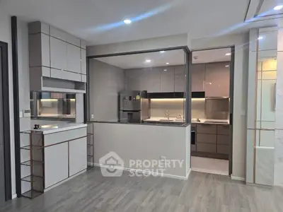 Modern kitchen with sleek cabinetry and open layout, featuring stainless steel appliances and stylish lighting.
