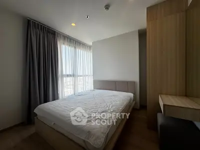 Modern bedroom with large window and stylish wooden furniture