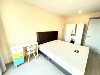 Bright and modern bedroom with stylish furniture and ample natural light.