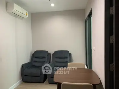 Cozy living room with plush recliners and dining table, perfect for relaxation and dining.