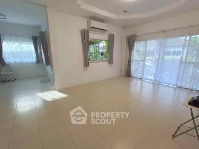 Spacious living room with large windows and natural light in modern home