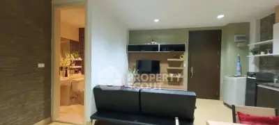 Modern living room with sleek furniture and open bathroom view
