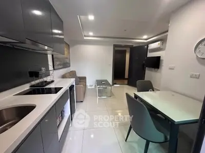 Modern open-layout kitchen and living area with sleek design and contemporary furnishings.