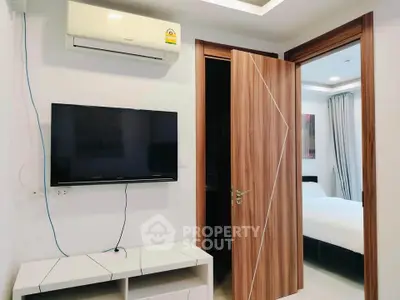 Modern bedroom with wall-mounted TV and air conditioning unit
