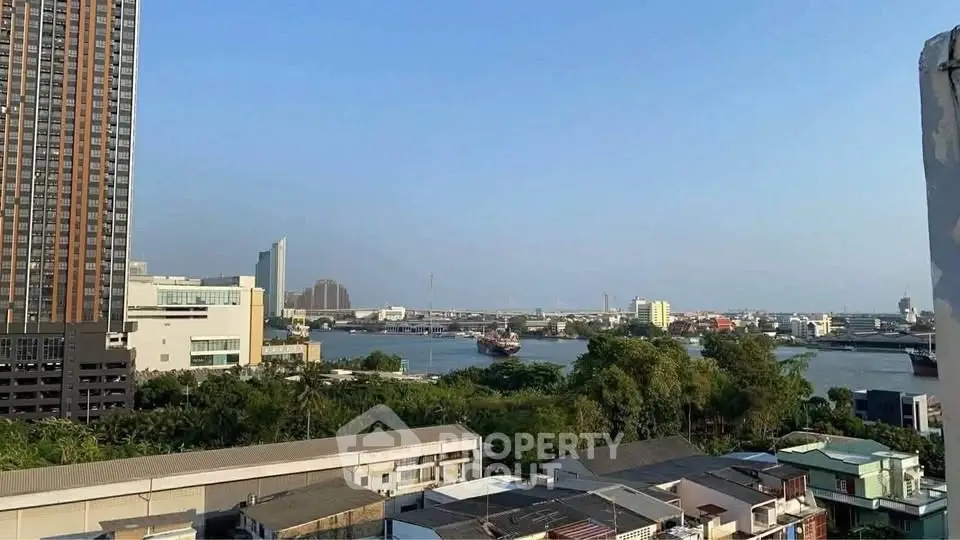 Stunning cityscape view from high-rise building overlooking river and skyline.
