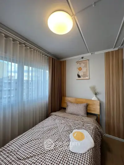 Cozy bedroom with checkered bedding and unique egg-themed decor