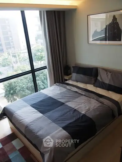 Modern bedroom with large window and stylish decor in urban apartment