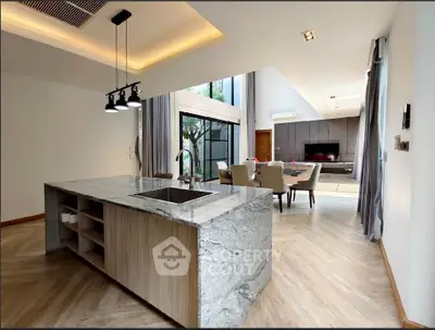 Luxurious open-plan living room with modern kitchen island and elegant dining area