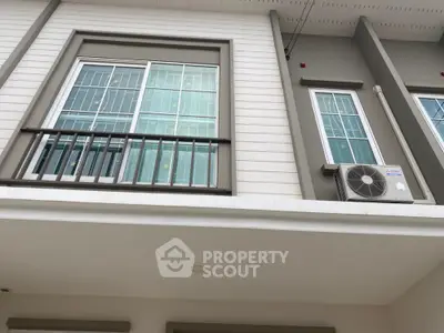 Modern building facade with large windows and air conditioning unit